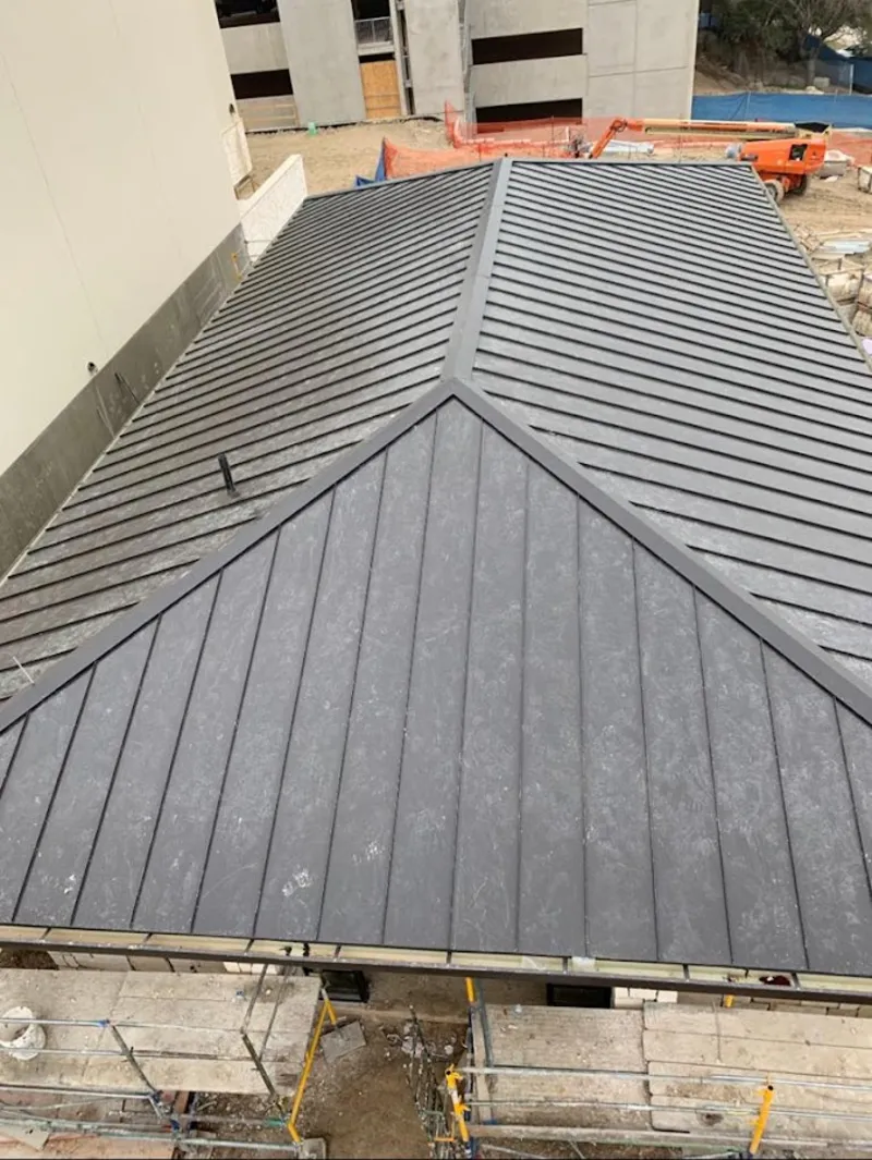 Commercial metal roof construction with crane equipment in Coeur d'Alene