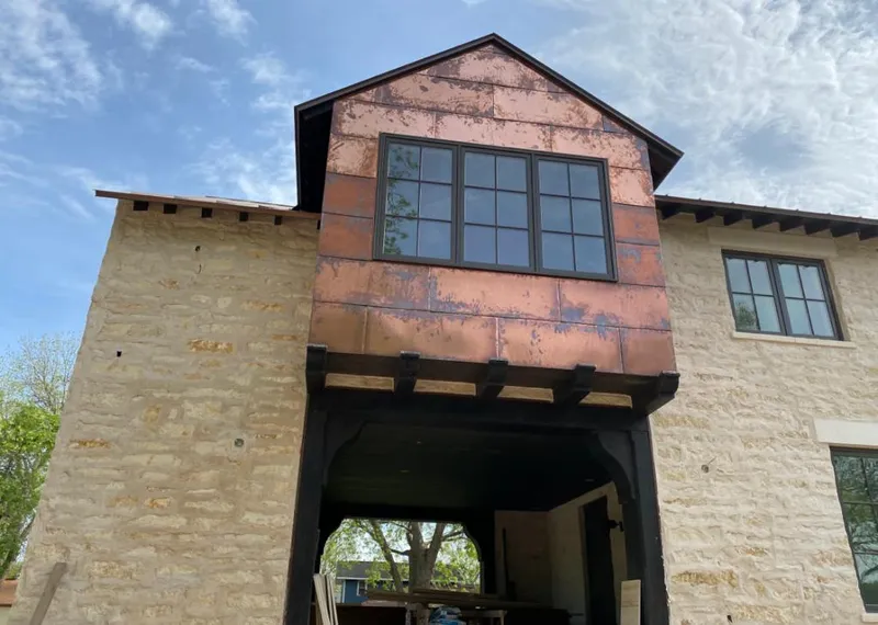 Copper metal panel facade on a stone building for Skylight Installation in Coeur d'Alene